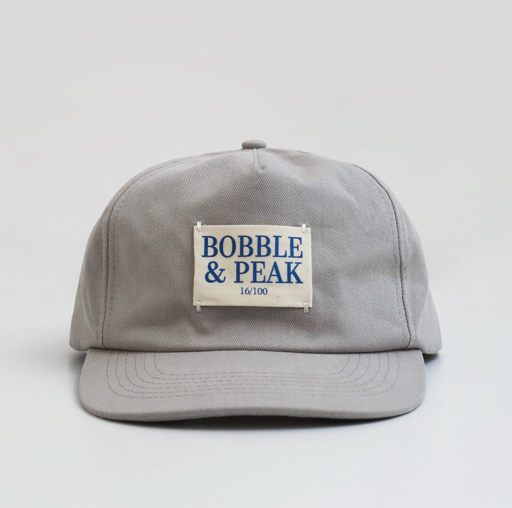 Close up of adjustable strap and branding on Grey Drop 003 cap
