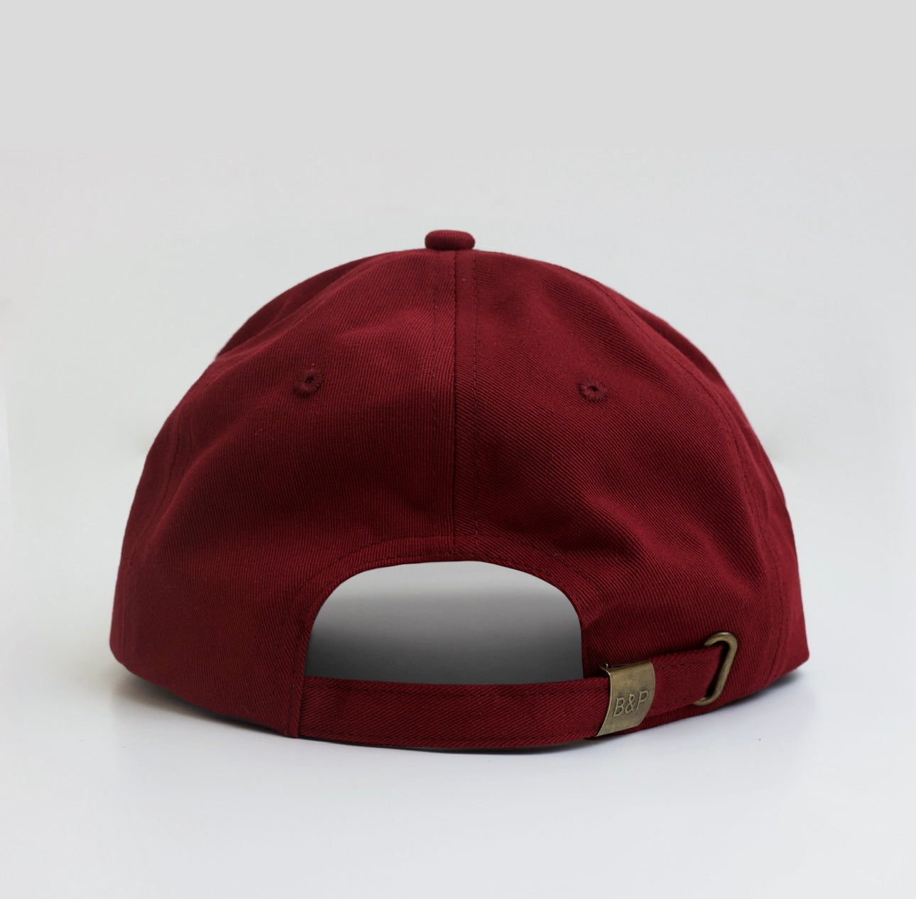 Claret limited edition hat side view showing subtle branding and premium finish
