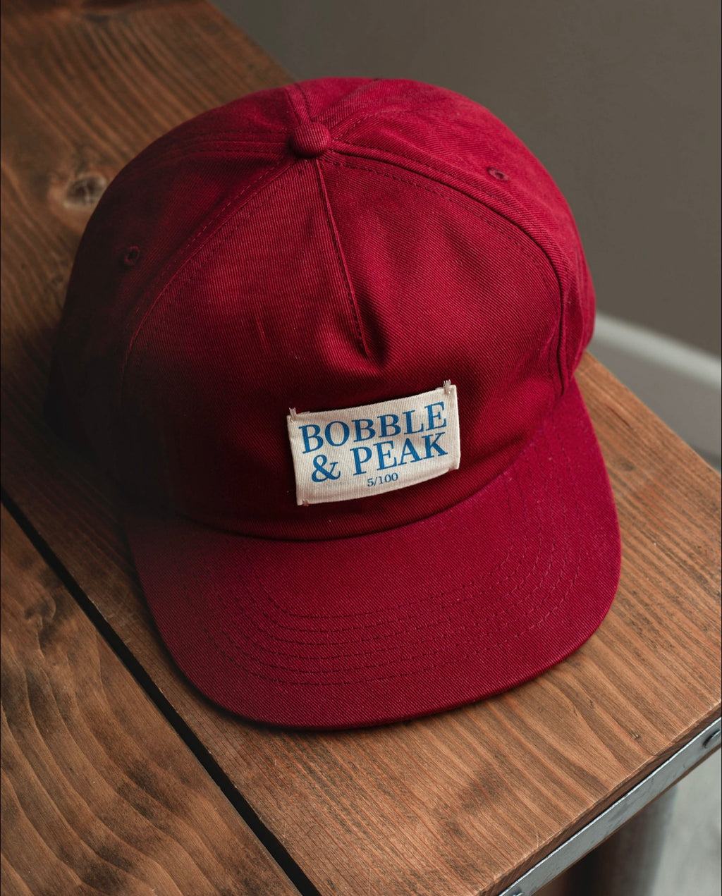 Limited edition claret hat presented in Bobble & Peak branded box packaging