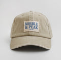 Limited edition oat white hat by Bobble & Peak with minimalist two‑tone design