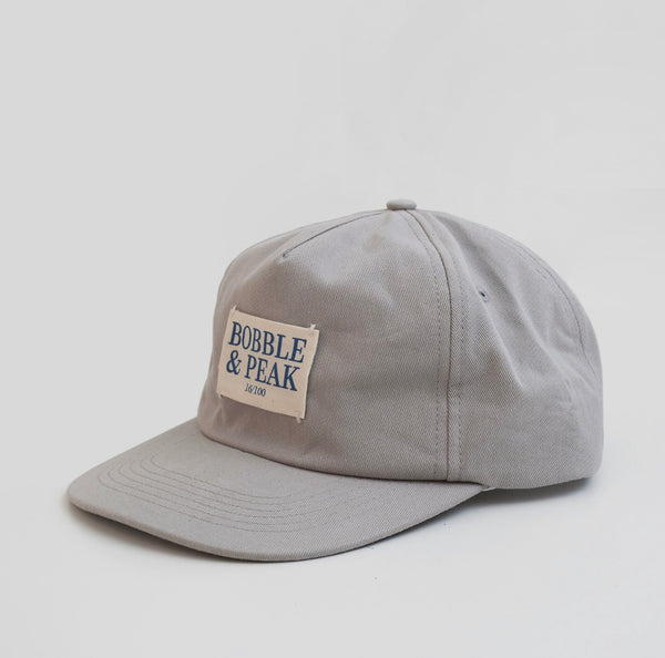 Front view of Bobble and Peak Drop 003 Grey baseball cap with logo