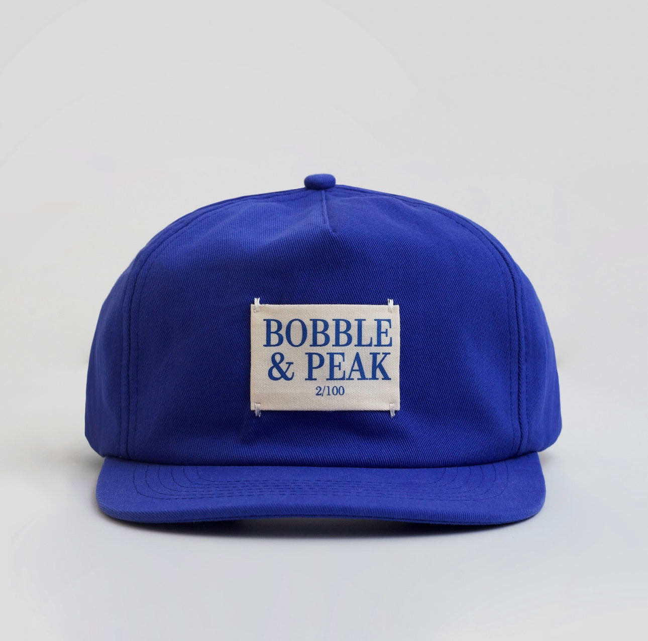 Adjustable strap-back detail on a premium navy blue 6-panel outdoor cap